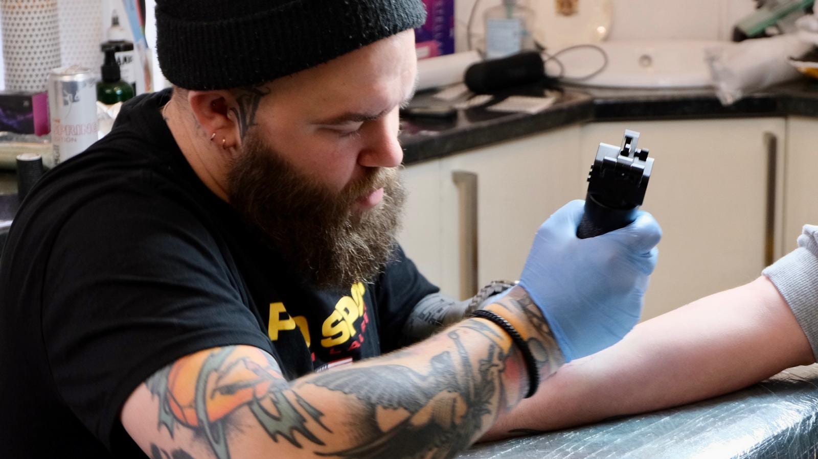 Tattoo artist working inside Acreedo in Abingdon